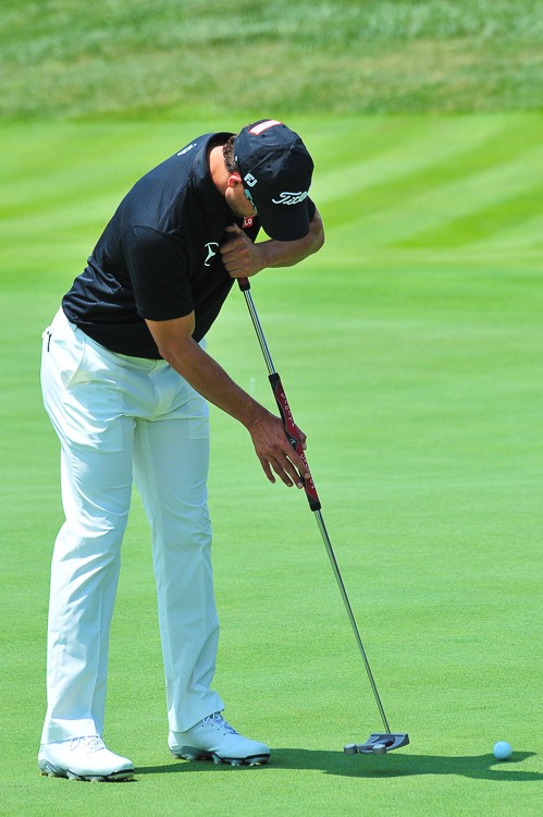 Adam Scott putts for birdie on eighteen during practice for the 2014 PGA Championship at Valhalla Country Club