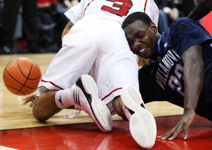 JayVaughn Pinkston crashes in to Peyton Siva while chasing for a loose ball as the Louisville men&#039;s basketball team took on Villanova at the KFC Yum! Center Wednesday January 25, 2012. Louisville won the game 84-74. Photo by Jeff Sainlar