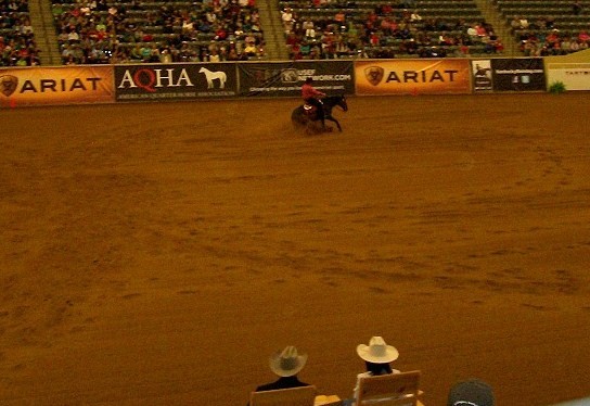 One of the competitors in the CR13* performs a sliding stop as judges look on.