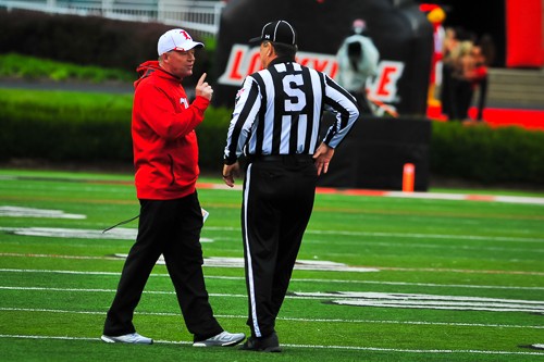 Bobby Petrino has a word with an official.