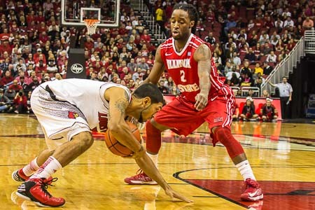 Peyton Siva nearly loses his footing while being guarded by Bryant Allen.