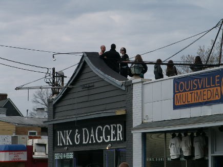 While most gathered along the street, some took to the rooftops for a better view.