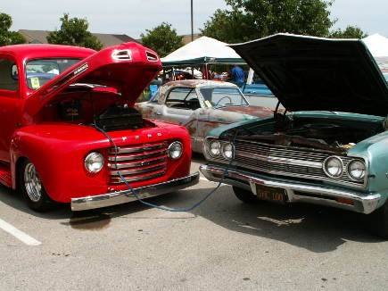 A Ford F-1 and a Chevrolet Chevelle share a moment while a Nash Metropolitan photobombs.