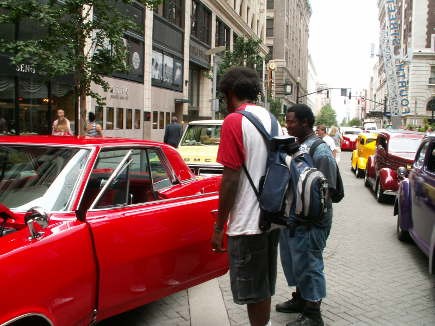 Onlookers took in the sight of machines such as this Pontiac Grand Prix.