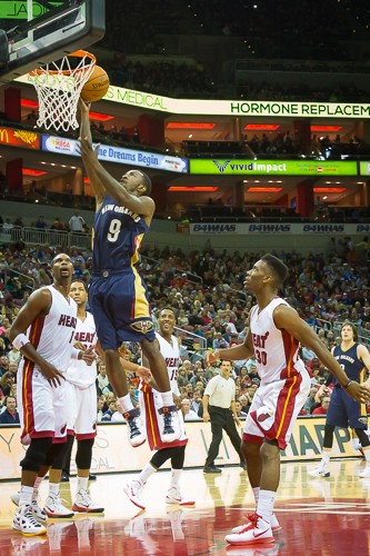 Russ Smith takes it to the hoop. Chris Bosh looks surprised.