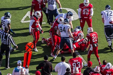 A scrum of Cards take down a ball carrier.
