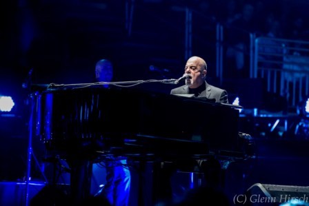 Billy Joel spotlighted while the stage was awash in blue