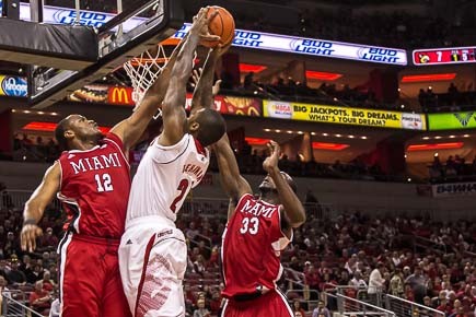 Chane Behanan goes for the dunk over Bill Edwards and Will Felder.