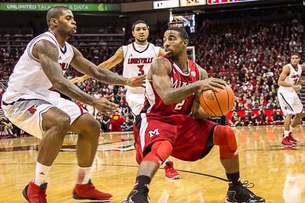 Chane Behanan stops Quinten Rollins on a drive while Peyton Siva waits for him to spin the other way.