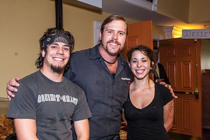 Chef Reed Johnson from Against the Grain posed with two of his workers before going back to make his Old Hickory Nachos