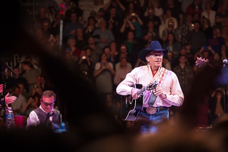 Even when just hooking up his guitar, the record crowd gave George Strait a standing ovation.jpg