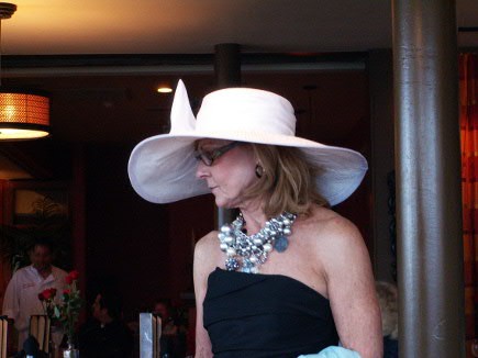 Big purses may be out, but big hats are still in for Oaks and Derby.