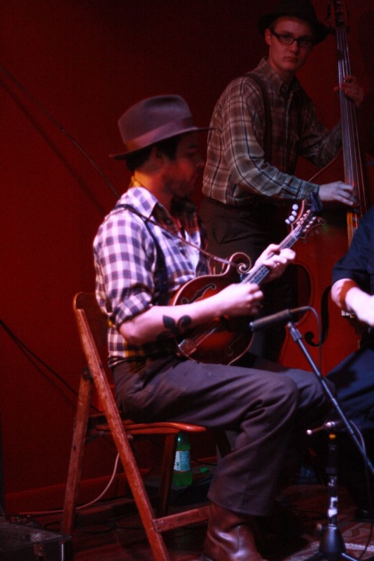 Johnny takes the mandolin while Leroy stands with his bass