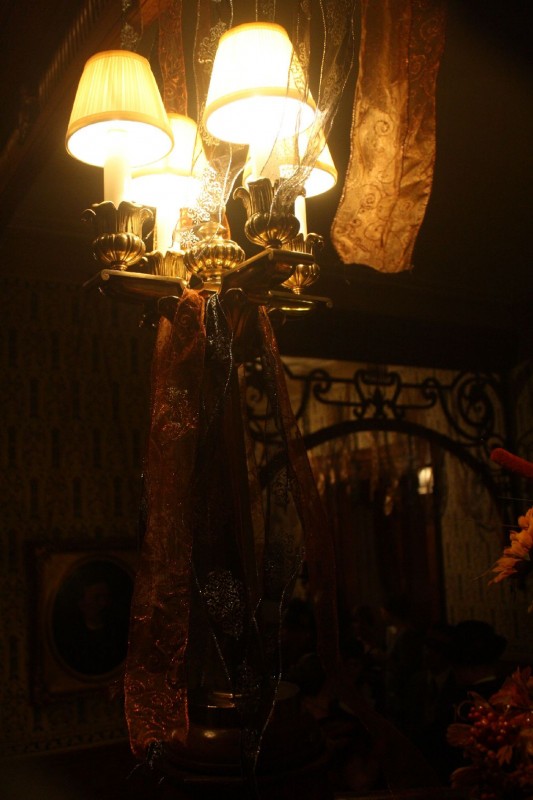 Period lighting throughout the home is decorated for the Halloween season