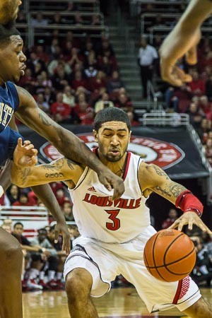 Peyton Siva (3) fouled by Tray Woodall on a drive to the hoop.