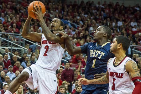 Russ Smith (2) blows past Tray Woodall (1) while Peyton Siva (3) looks on.