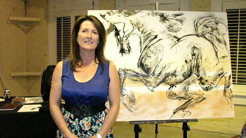 Laura Bernstein with the artwork she did during the event that was part of the silent auction.