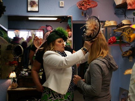Jenny Pfanestiel of Formé Millinery helps a client with a fascinator.