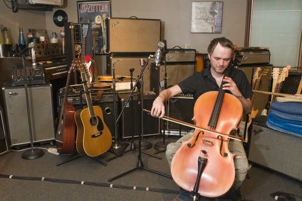 Tyler Morrison plays cello in the live recording room, Thursday, July 26, 2012, at Liquid Sound Studios in Greenville, Ind. Morrison, a percussionist for 27 years, has also played cello for 24 years, along other instruments. (Photo by Brian Bohannon)