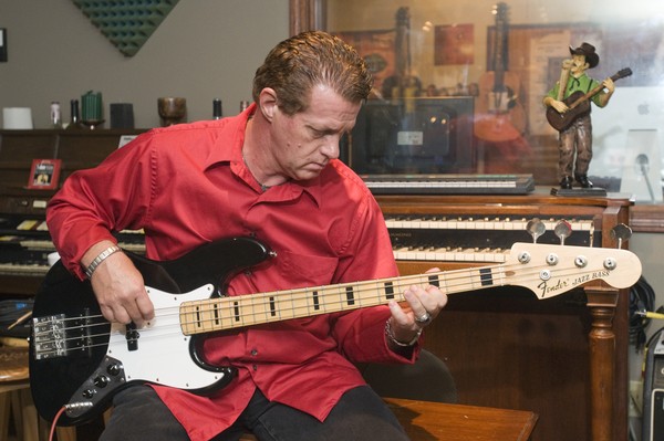 Wise Doc Smith plays electric bass in the live recording room, Thursday, July 26, 2012, at Liquid Sound Studios in Greenville, Ind. (Photo by Brian Bohannon)