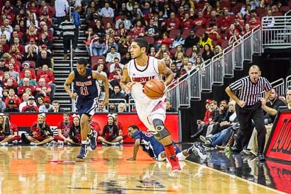 Louisville&#039;s Peyton Siva looks like the NBA logo as he pushed the ball down court.