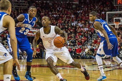 Russ Smith drives around Fuquan Edwin (23) and Aaron Cosby (1).