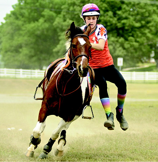 Mary Peabody Camp vaulting on pony Speedy during a mounted games event.