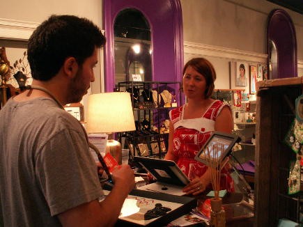 Mary Levinsky, owner of Block Party Handmade Boutique, helping a customer with a purchase.