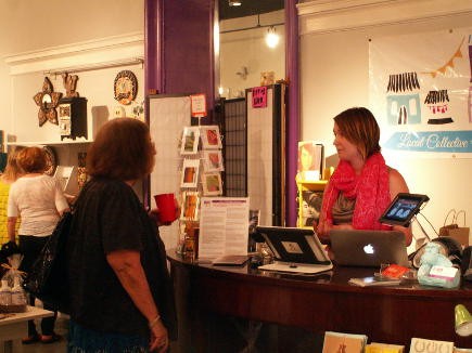 Block Party Homemade Boutique owner Mary Levinsky speaking with a customer about her boutique.