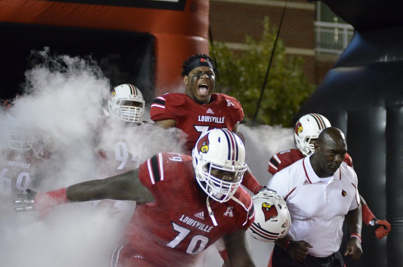 Louisville&#039;s George Durant bursts out of the tunnel before the game Saturday night