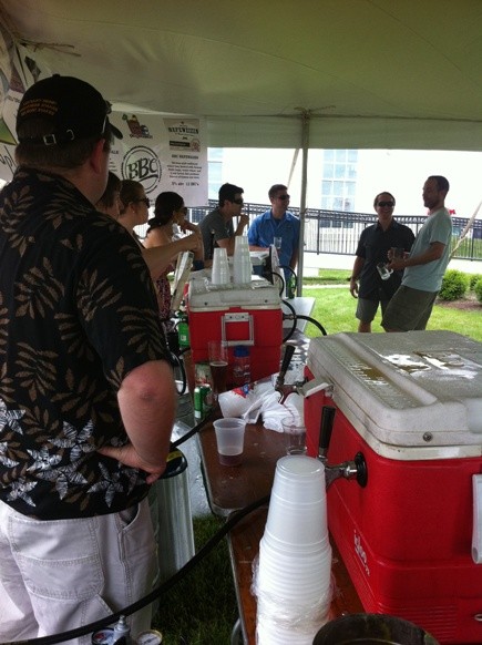 Volunteers pour beer at the Craft Beer Tent